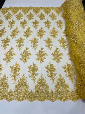 Gold Metallic floral design embroidery on a mesh lace with sequins and cord-sold by the yard.